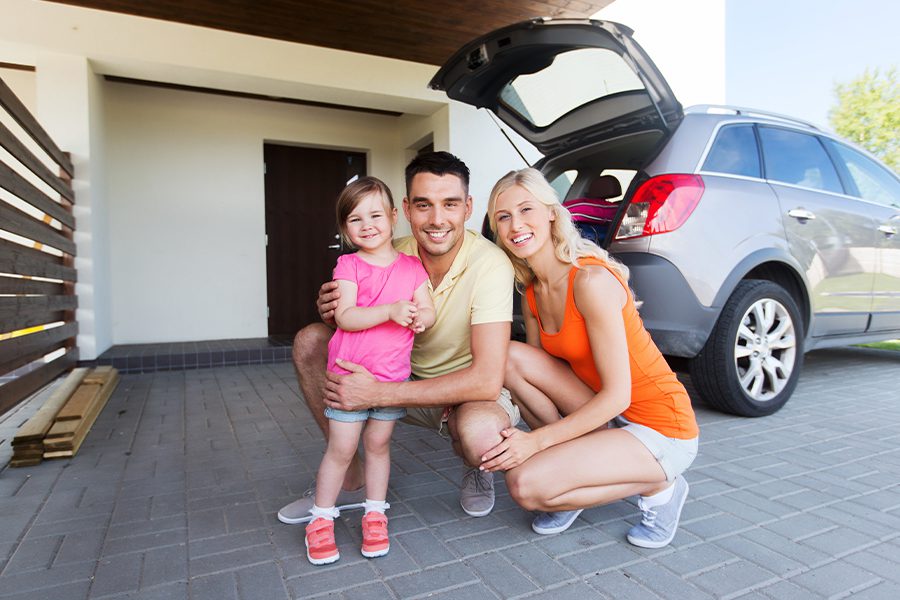 Personal Insurance - Happy Family with a Hatchback Car in Front of Home